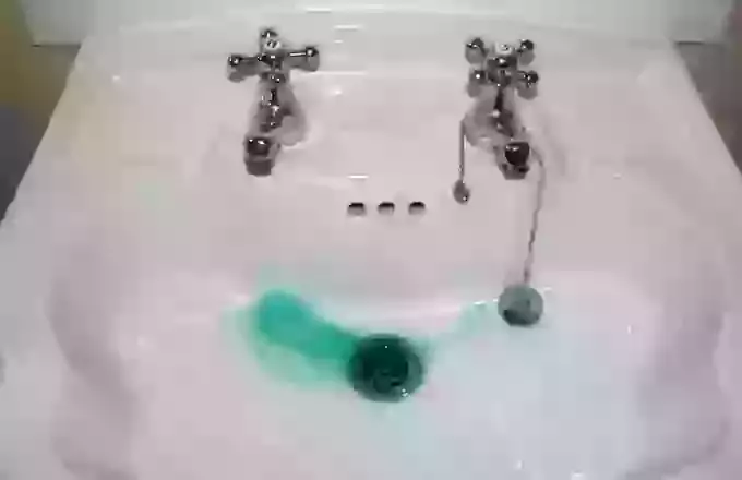 What causes blue-green stains in water?